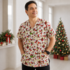 Man wearing a Christmas-themed shirt in a room with decorated trees.