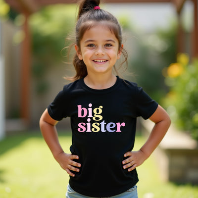 Young girl wearing a black t-shirt with 'big sister' text, standing outdoors.