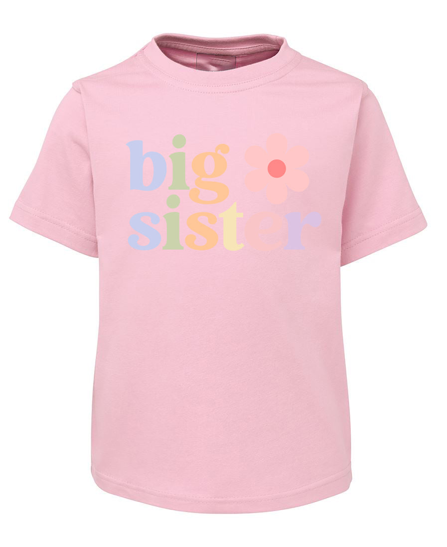 Pink t-shirt with 'big sister' text on a white background