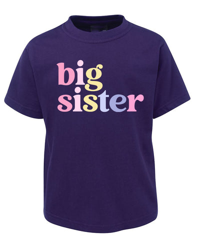 Purple t-shirt with 'big sister' text in colorful letters on a white background