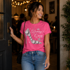 Woman wearing a pink t-shirt with 'Birthday Queen' design, standing indoors.