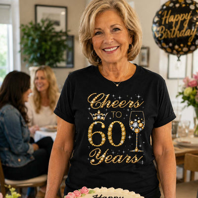 Woman wearing a black t-shirt with 'Cheers to 60 Years' at a birthday celebration.