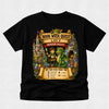 A black short-sleeve t-shirt with a colorful graphic print on the front. The graphic features a cartoon boy holding a sword next to a green dragon, set against a fantasy castle and treasure scene with text reading 'BOOK WEEK QUEST', 'LUCY', and 'DRAGON VALLEY'.