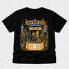 A black short-sleeve t-shirt with a large, colorful graphic print on the front. The graphic features a medieval knight in blue armor on a white horse, set against a castle with banners reading 'BOOK WEEK QUEST', 'KNIGHTS CASTLE', and 'FINLAY'.