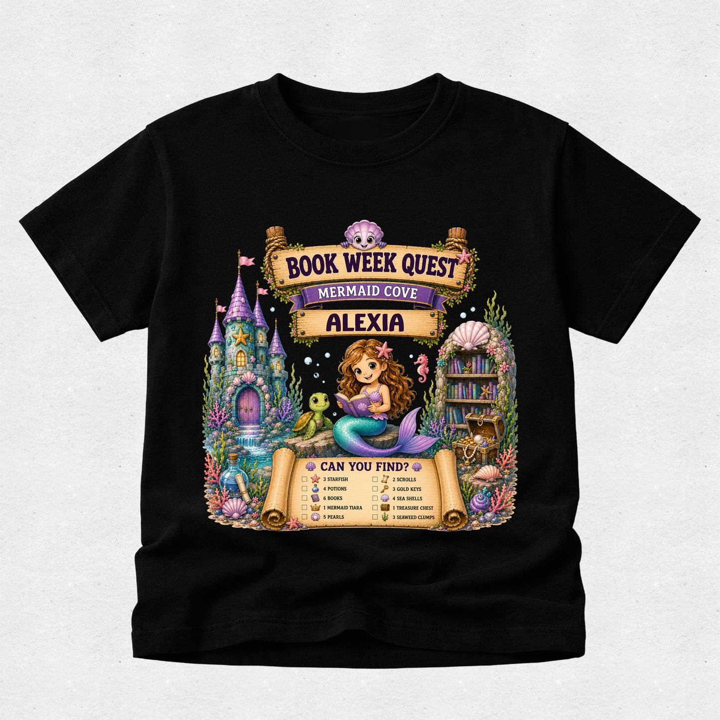 A black short-sleeve t-shirt with a colorful graphic print on the front. The graphic features a mermaid, a castle, a library, and scrolls reading 'BOOK WEEK QUEST', 'MERMAID COVE', and 'ALEXIA', along with a checklist at the bottom.