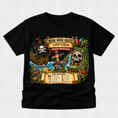 A black short-sleeve crewneck t-shirt featuring a large, colorful pirate-themed graphic on the front. The graphic depicts a book-themed pirate adventure with a ship, skull, treasure chest, and a pirate character, with text reading 'BOOK WEEK QUEST HAYDEN PIRATE ADVENTURE' and a checklist at the bottom.