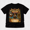 A black short-sleeve crewneck t-shirt featuring a large, colorful graphic print on the front. The graphic is themed around a pirate queen book club event, titled 'Book Week Quest: Annabel Pirate Queen Adventure', with illustrations of a pirate, a ship, a treasure chest, and a scroll showing a 'Can You Feed?' food challenge.