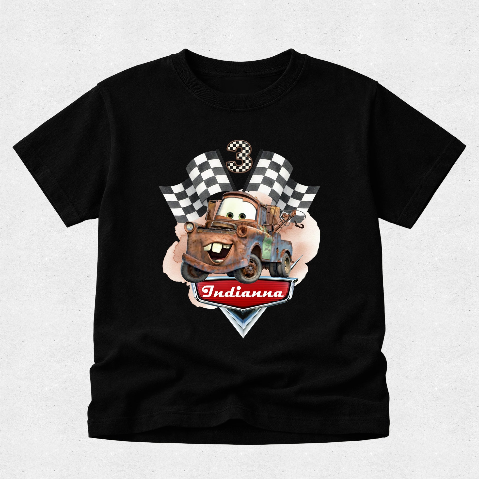 Black t-shirt with a cartoon truck graphic and 'Indianna' text on a light gray background