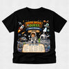 A black short-sleeve t-shirt with a colorful graphic print on the front. The graphic features an astronaut, rockets, a space rover, and a banner that reads 'BOOK WEEK QUEST SPACE MISSION ADAM' along with a 'CAN YOU FIND?' checklist at the bottom, displayed against a light gray background.