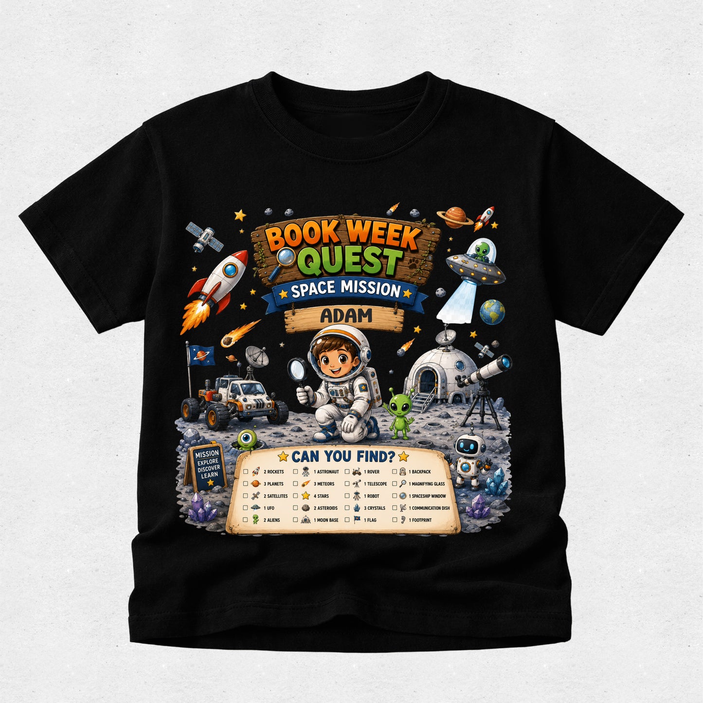A black short-sleeve t-shirt with a colorful graphic print on the front. The graphic features an astronaut, rockets, a space rover, and a banner that reads 'BOOK WEEK QUEST SPACE MISSION ADAM' along with a 'CAN YOU FIND?' checklist at the bottom, displayed against a light gray background.