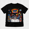 A black short-sleeve crewneck t-shirt featuring a colorful graphic print for 'Book Week Quest Comic City 2024' with cartoon superheroes, books, and comic elements, displayed on a light gray textured background.