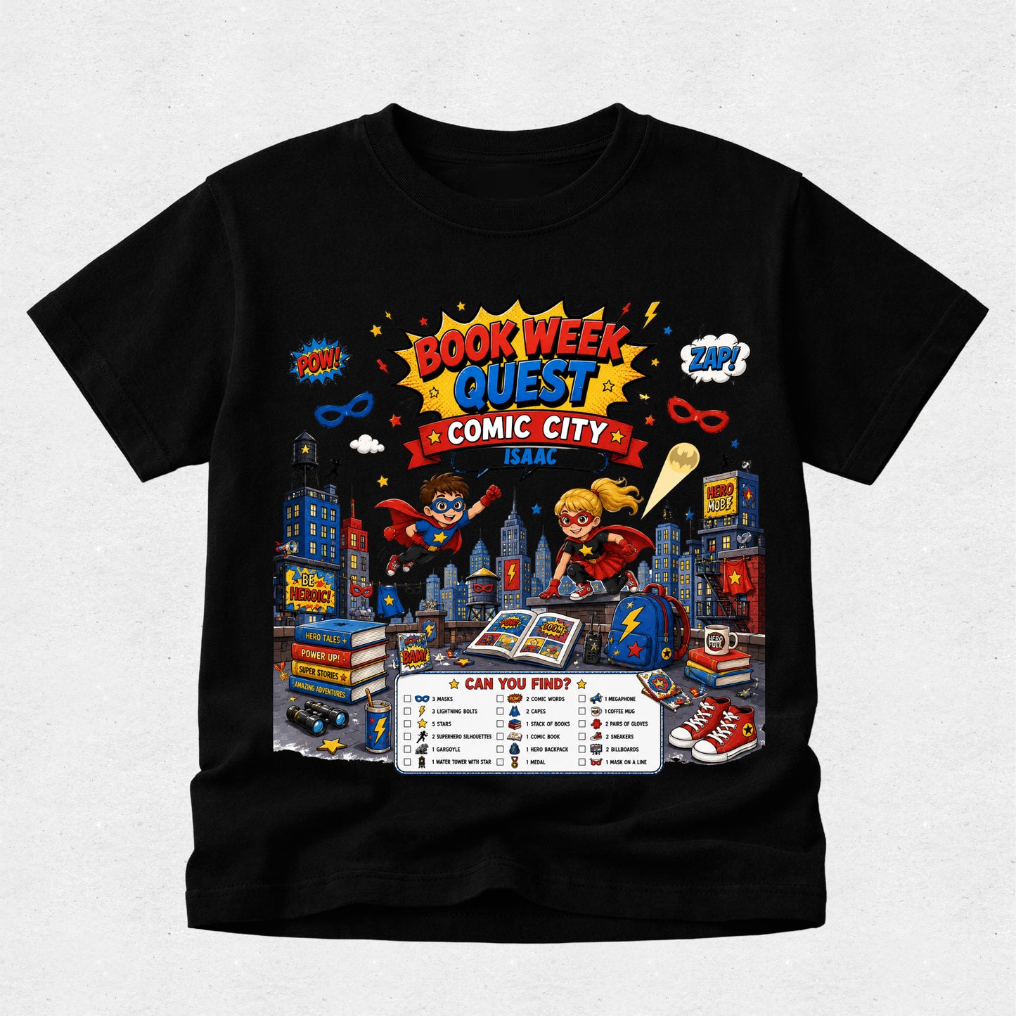 A black short-sleeve crewneck t-shirt featuring a colorful graphic print for 'Book Week Quest Comic City 2024' with cartoon superheroes, books, and comic elements, displayed on a light gray textured background.