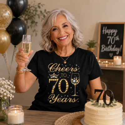 Woman celebrating her 70th birthday with a cake and champagne.
