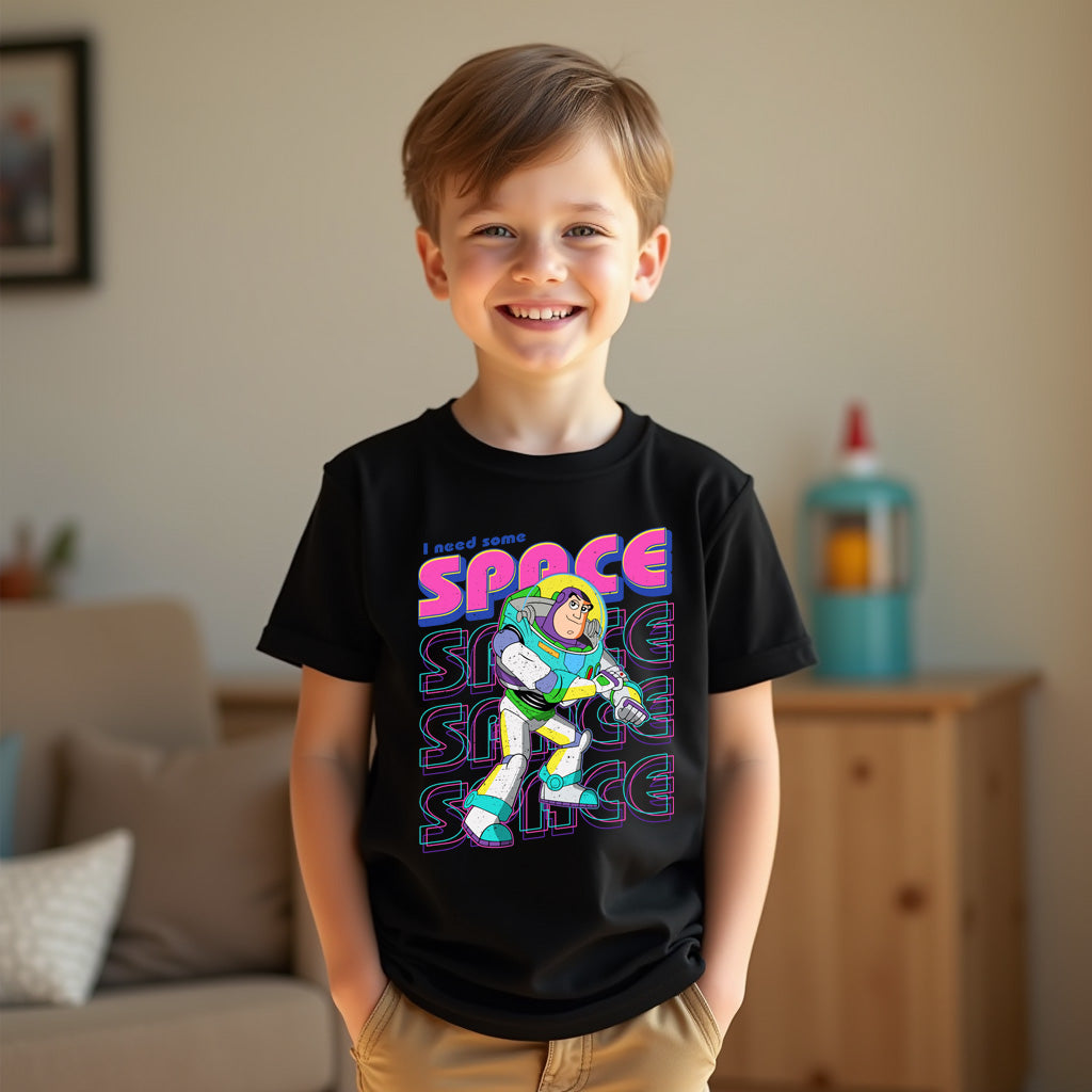 Child wearing a black t-shirt with a colorful graphic design in a living room setting