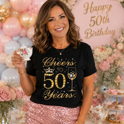 Woman celebrating a 50th birthday with decorative balloons and flowers.