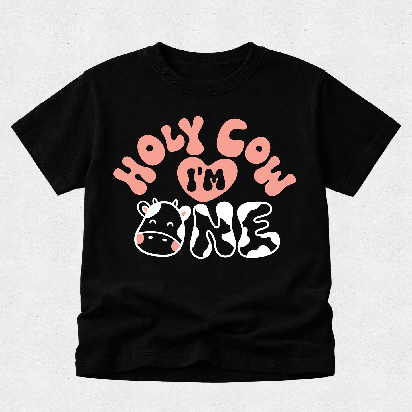 Black toddler birthday shirt featuring "Holy Cow I'm One" with cow print lettering, pink accents and a cute cow face for a farm-themed first birthday.