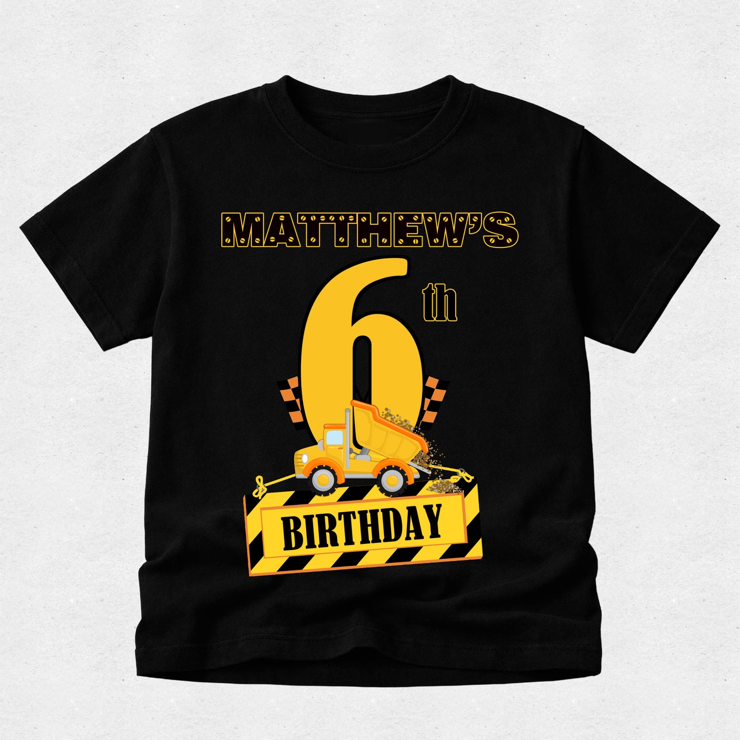 Black t-shirt with a construction-themed birthday design on a light gray background