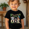 Child wearing a black t-shirt with animal-themed design and text, standing indoors.