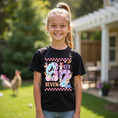 Young girl wearing a kpop easter black t-shirt with colorful design, standing outdoors.