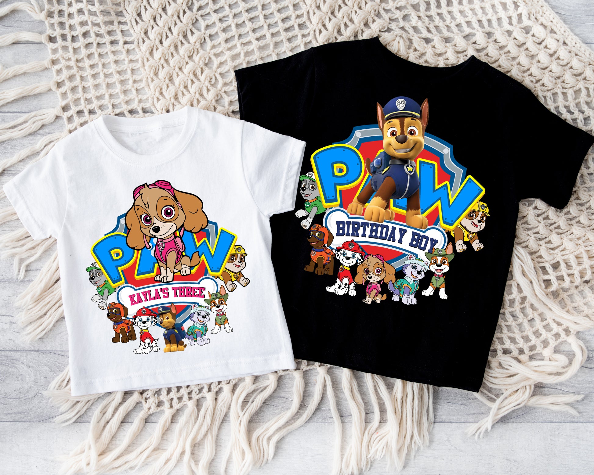 Flat lay of custom Skye-themed birthday t-shirt with bright pink "PAW" lettering and personalized name "Octavia".