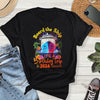 Black t-shirt with colorful ship graphic and text 'Board the Ship It's a Birthday Trip 2026' on a wooden surface with jeans and shoes.