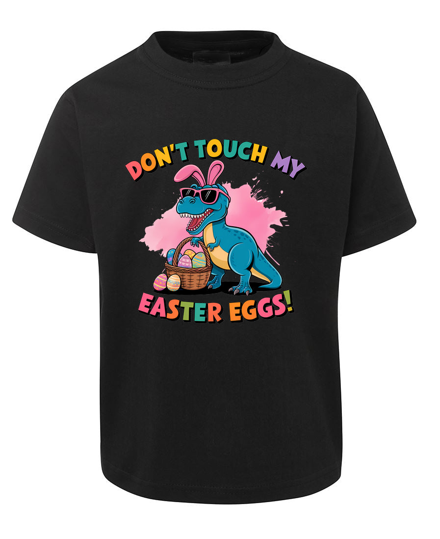 Black t-shirt with a colorful dinosaur graphic and Easter text on a white background