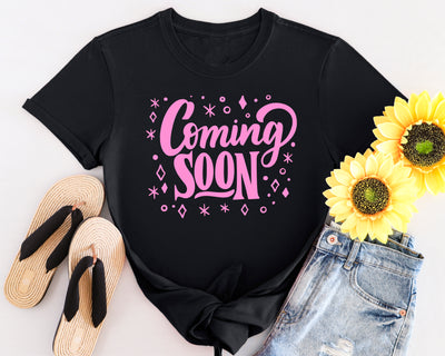 Pregnant woman wearing “Coming Soon” maternity shirt for pregnancy reveal or photo shoot.