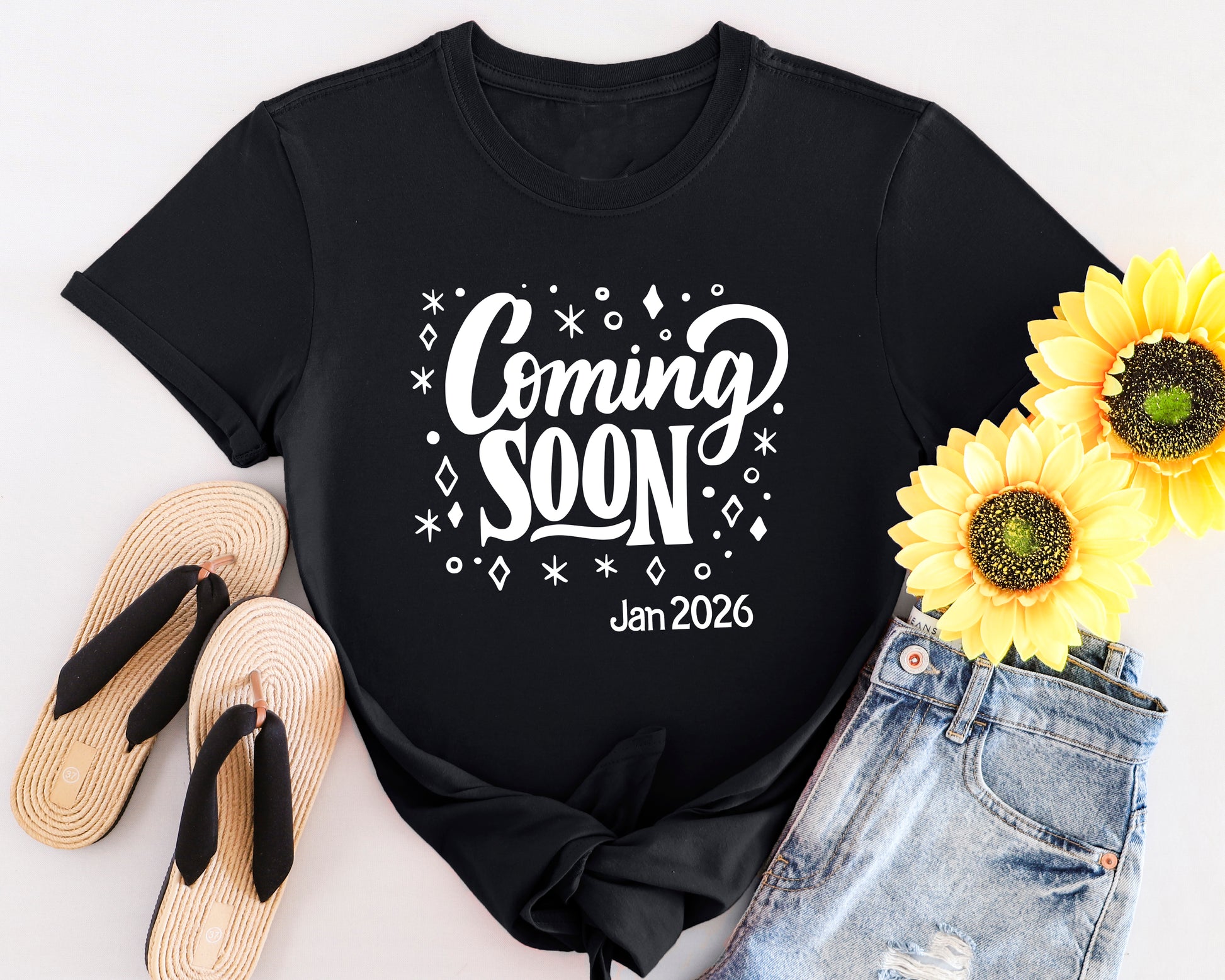 White t-shirt with “Coming Soon” text design, styled for pregnancy announcements and maternity wear.