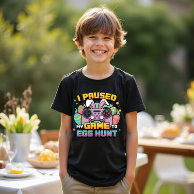 Child wearing a black t-shirt with Easter-themed text and graphics outdoors.
