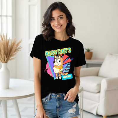 Woman wearing a black t-shirt with colorful graphic design in a living room.