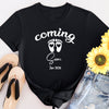 Classic style maternity shirt with “Coming Soon” text and baby footprints graphic, perfect for pregnancy announcements.