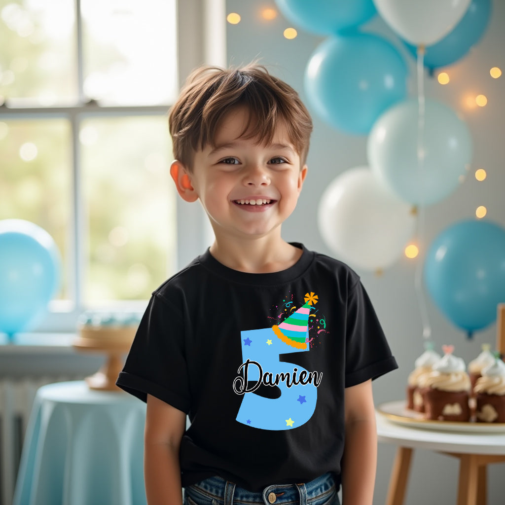 Child wearing a black t-shirt with a colorful number '3' design, standing in a room with balloons and birthday decorations.
