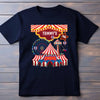 Black t-shirt with a colorful circus design on a wooden background