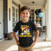 Child wearing a black t-shirt with birthday graphics and text, standing outdoors. Gotta catch 'em all