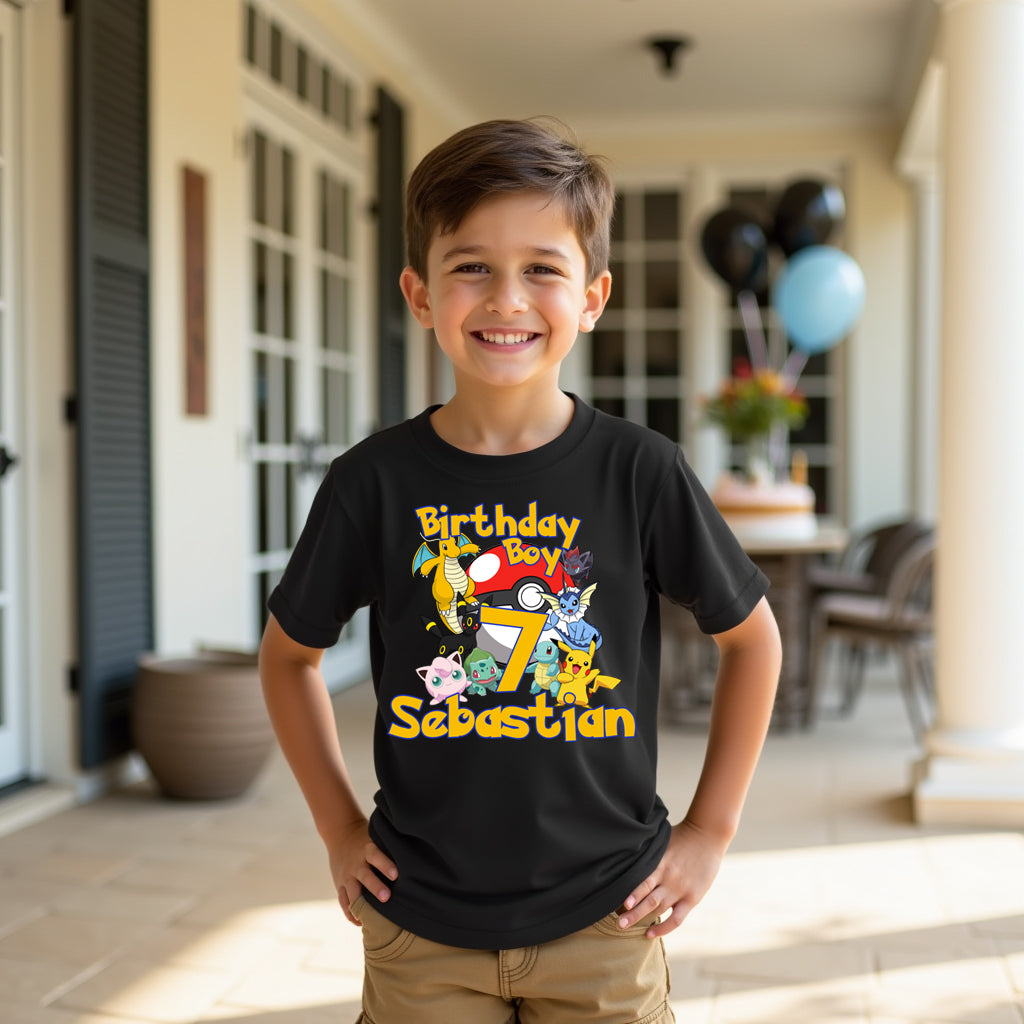 Child wearing a black t-shirt with birthday graphics and text, standing outdoors. Gotta catch 'em all