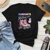 Black t-shirt with 'Hannah's Rolling into 8' design on a wooden surface with jeans and sneakers.