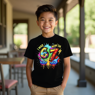 Child wearing a black t-shirt with colorful design and text reading 6 7, standing indoors.
