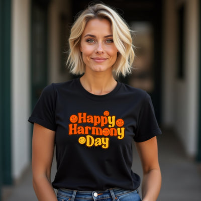Woman wearing a black t-shirt with 'Happy Harmony Day' text.