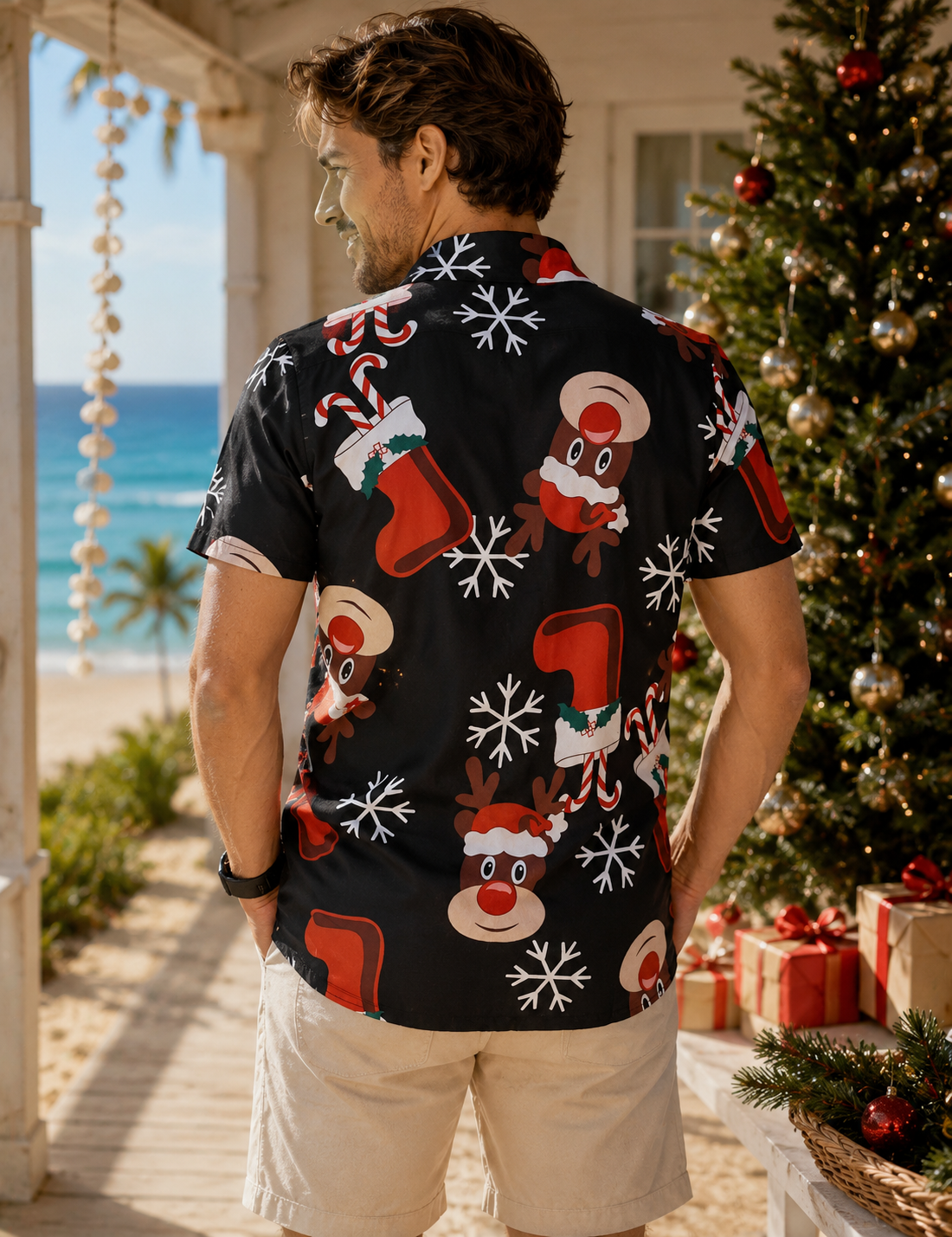 Man wearing a Christmas-themed shirt with beach and decorated tree in the background