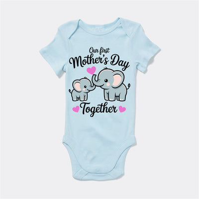 Light blue baby onesie with elephant design and text on a white background