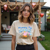 Woman wearing a beige t-shirt with 'Mummy Pig Party Patrol' design outdoors.