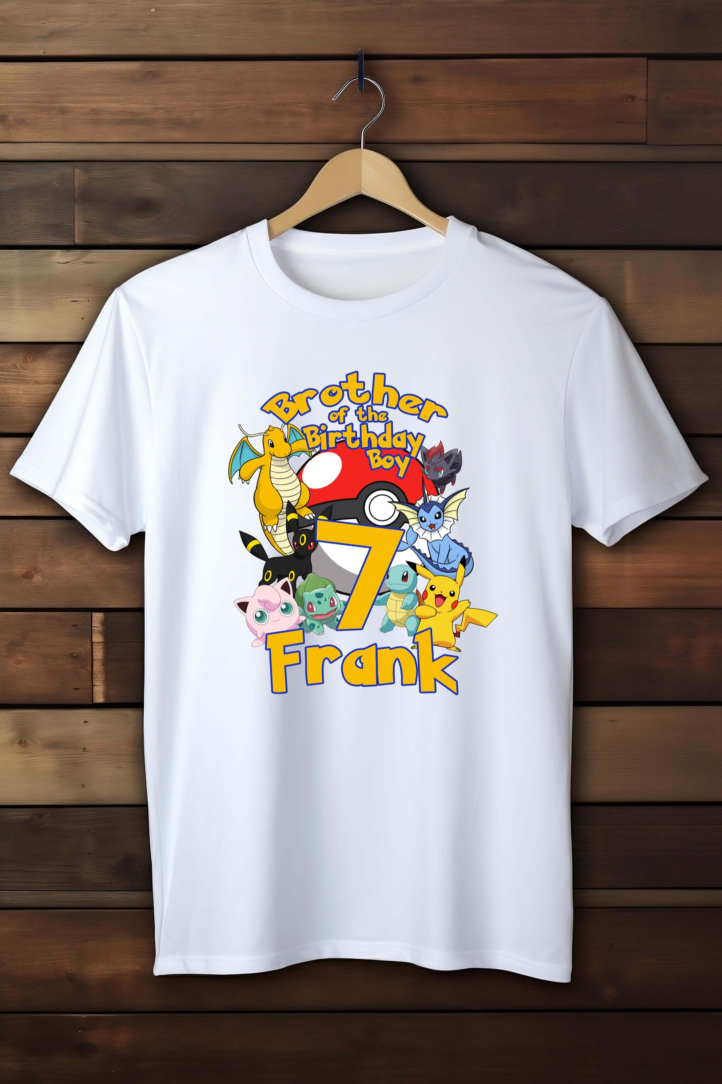 White t-shirt with colorful graphics and text on a wooden background