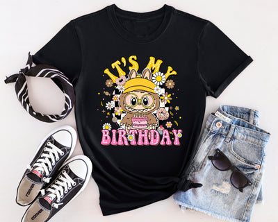 Caramel Crunch Labubu birthday party t-shirt featuring monster character design with balloon and gift details.
