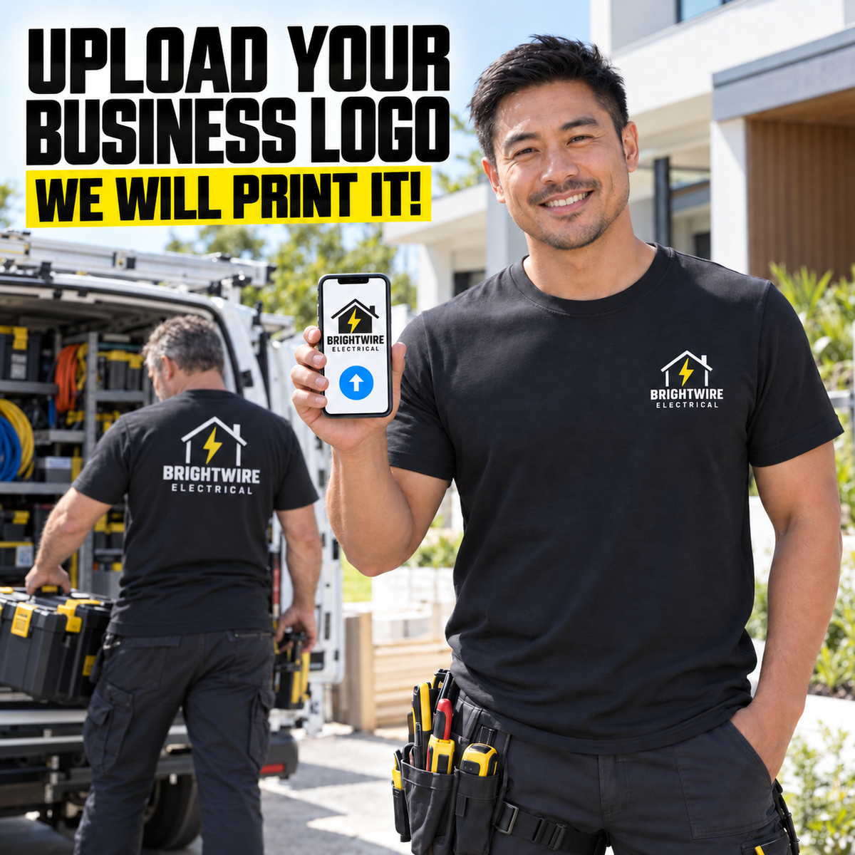 A smiling man in a black Brightwire Electrical t-shirt stands outdoors in front of a work van, holding up a smartphone that displays a custom business logo. Another man is visible in the background working at the van.
