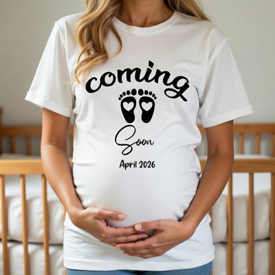 Expecting mum wearing a “Coming Soon” t-shirt with footprints design, ideal for baby reveal or bump photo shoot.