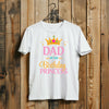 White t-shirt with 'Dad of the Birthday Princess' text and crown graphic on a wooden background