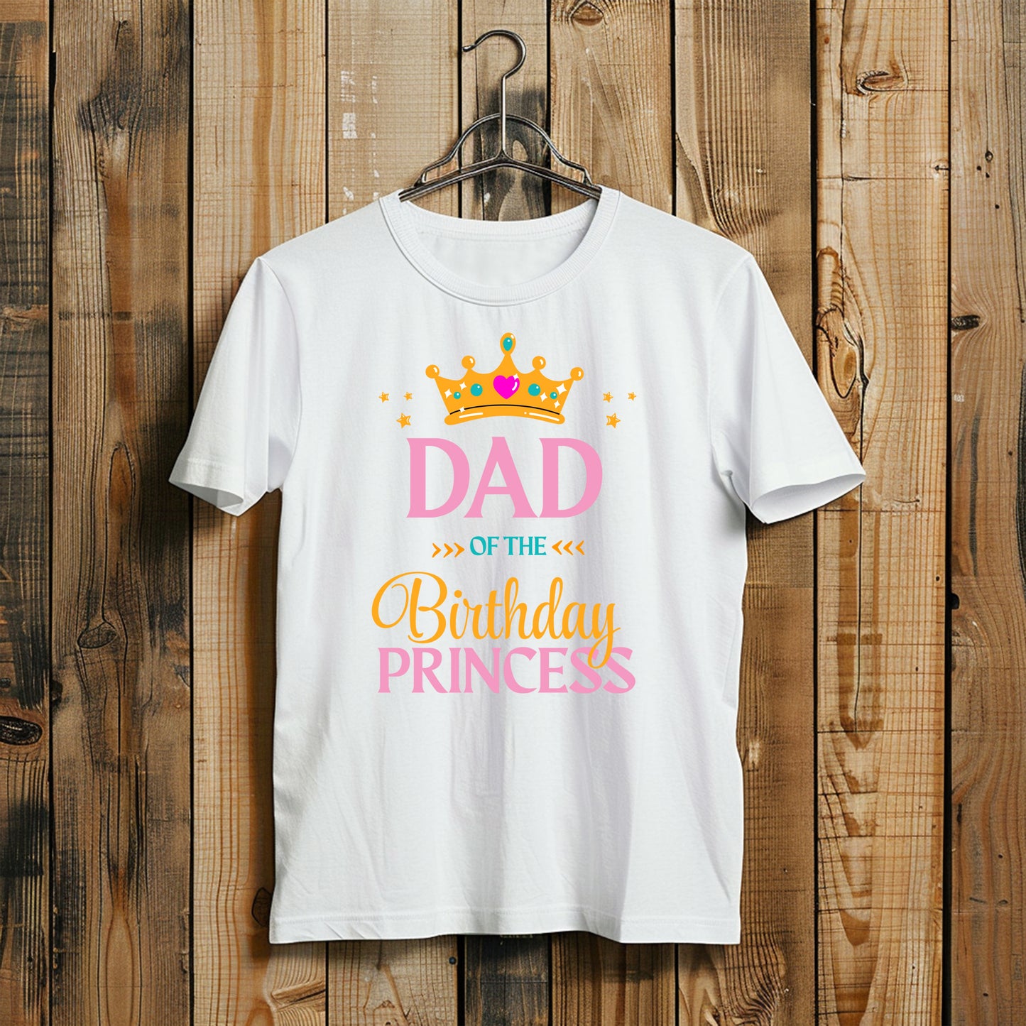White t-shirt with 'Dad of the Birthday Princess' text and crown graphic on a wooden background