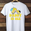 White t-shirt with bee graphics and 'Daddy to Bee' text on a wooden background