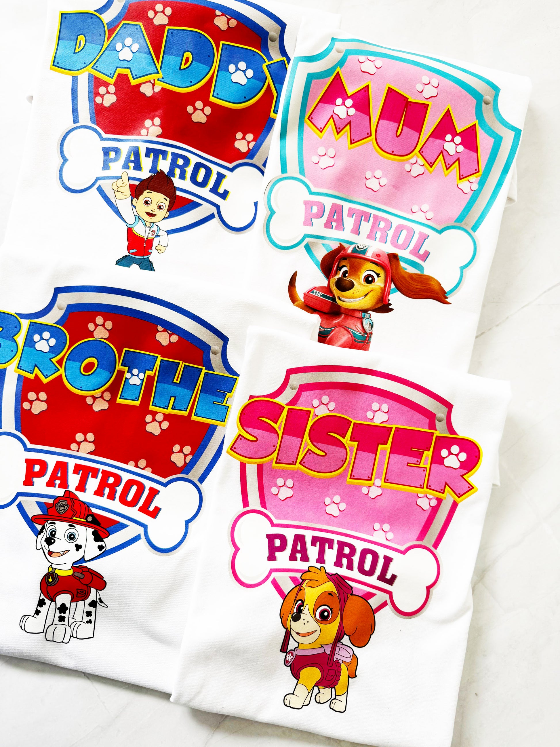 Pup Patrol Family Shirt bundle including Mum, Dad, sibling, and birthday pup tees laid out together