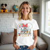Woman wearing a white t-shirt with Disney-themed design in a living room.